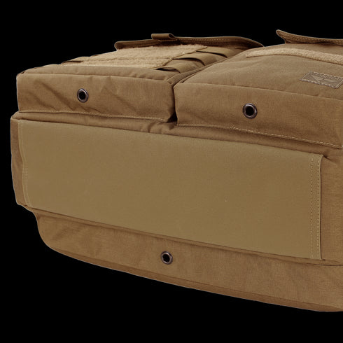 Close-up view of the bottom and side of the Condor Elite Metropolis Briefcase by Condor, featuring brown tactical fabric, grommet holes, and reinforced stitching.